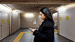Phone, subway and Japanese woman on internet, social media and walking to travel in Tokyo. Smartphone, scroll and serious person on app, reading email and information on mobile website on commute