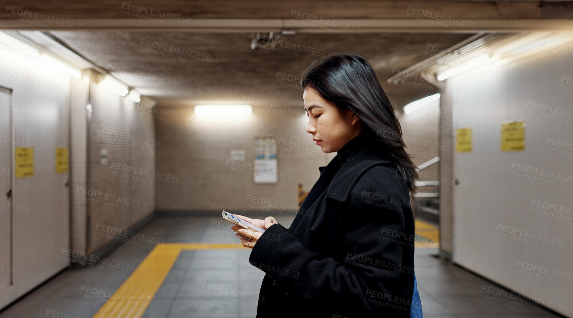 Buy stock photo Phone, subway and Japanese woman on internet, social media and walking to travel in Tokyo. Smartphone, scroll and serious person on app, reading email and information on mobile website on commute