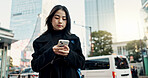 Smartphone, city and Japanese woman on social media, reading email or notification in Tokyo. Phone, mobile and serious person in urban street outdoor for communication technology, network or internet
