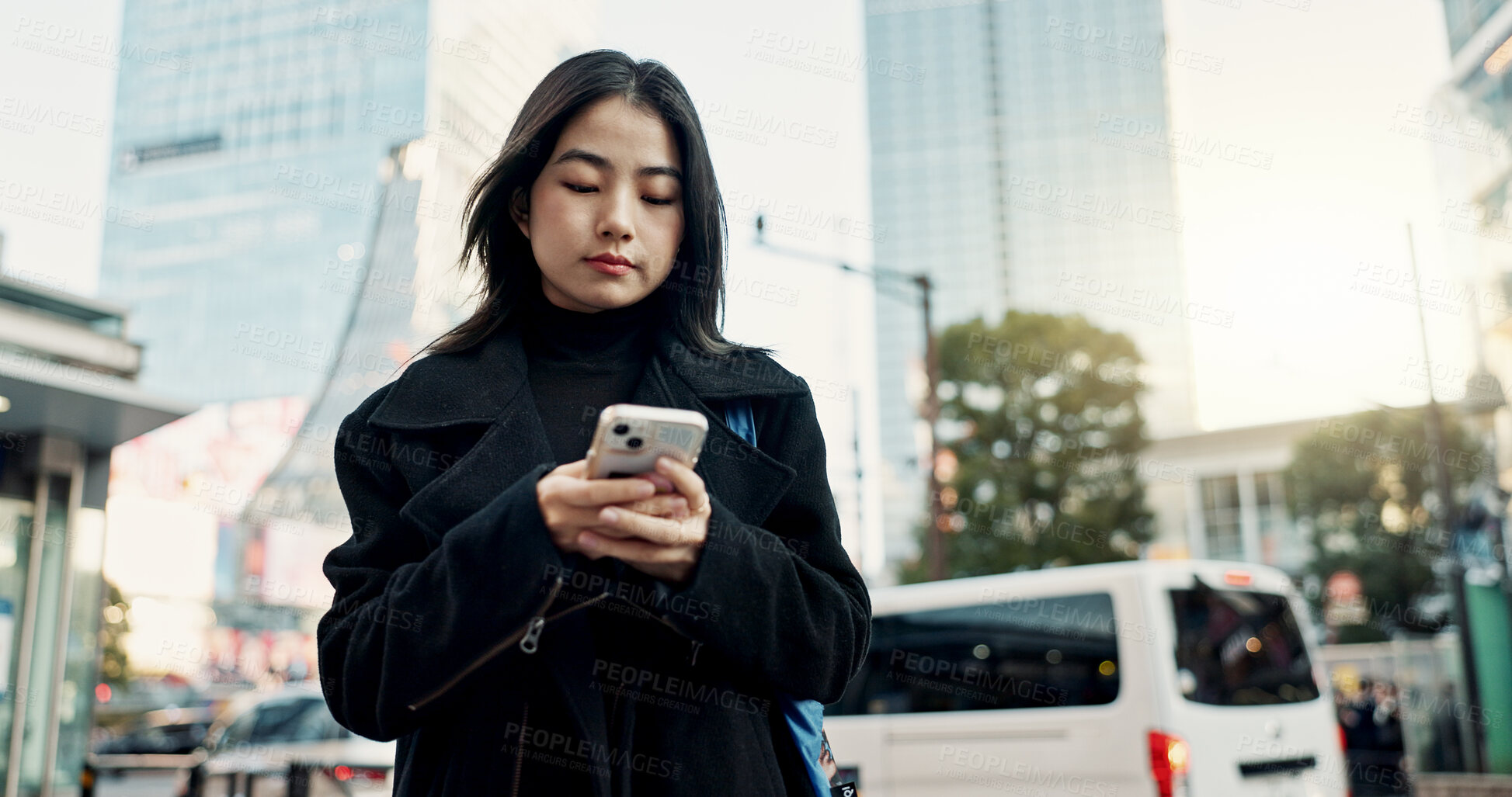 Buy stock photo Smartphone, city and Japanese woman on social media, reading email or notification in Tokyo. Phone, mobile and serious person in urban street outdoor for communication technology, network or internet
