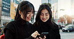 Smartphone, friends and happy women in city for travel, social media and connection together in Japan. Phone, smile and girls in urban street outdoor, reading info or network on technology in Tokyo