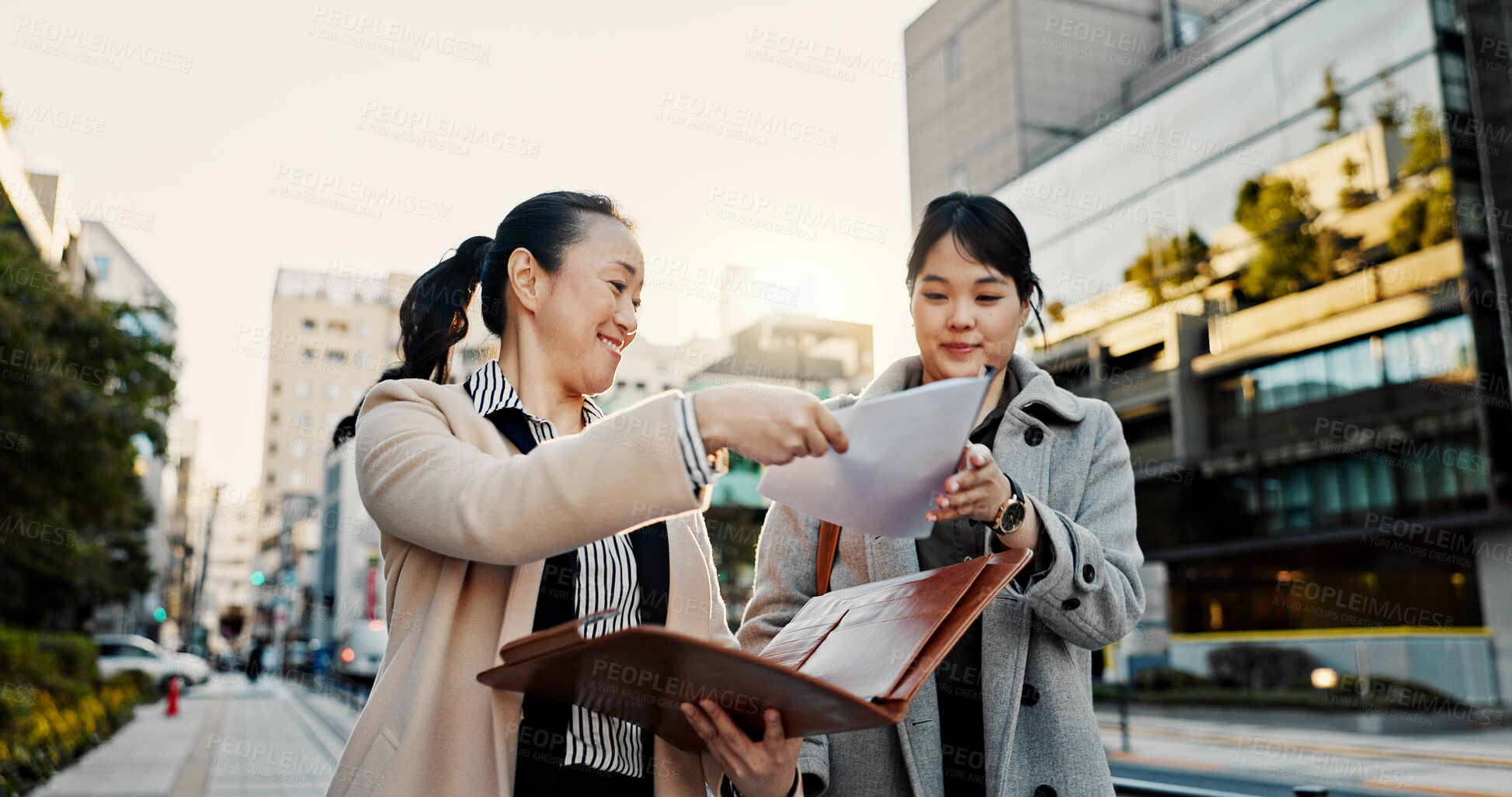 Buy stock photo Documents, discussion and Japanese business people in city for morning commute, travel and walking. Collaboration, corporate team and women with paperwork for meeting, talking and project in Tokyo