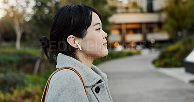 Buy stock photo Japanese woman, earphones and walk in street with listening, music and streaming subscription in city. Business person, audio tech and sound for podcast, radio and travel on metro sidewalk in Tokyo