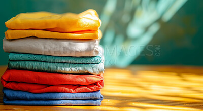 Buy stock photo Clothing, clean and folded laundry for laundromat business service, background or cleaning detergent backdrop. Colourful, neat and pile of shirts for mockup, wardrobe and eco friendly product