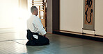 Asian man, sensei and bow in dojo for honor, greeting or respect to master at indoor gym. Male person or karate trainer bowing in class for etiquette, attitude or commitment in martial arts on floor