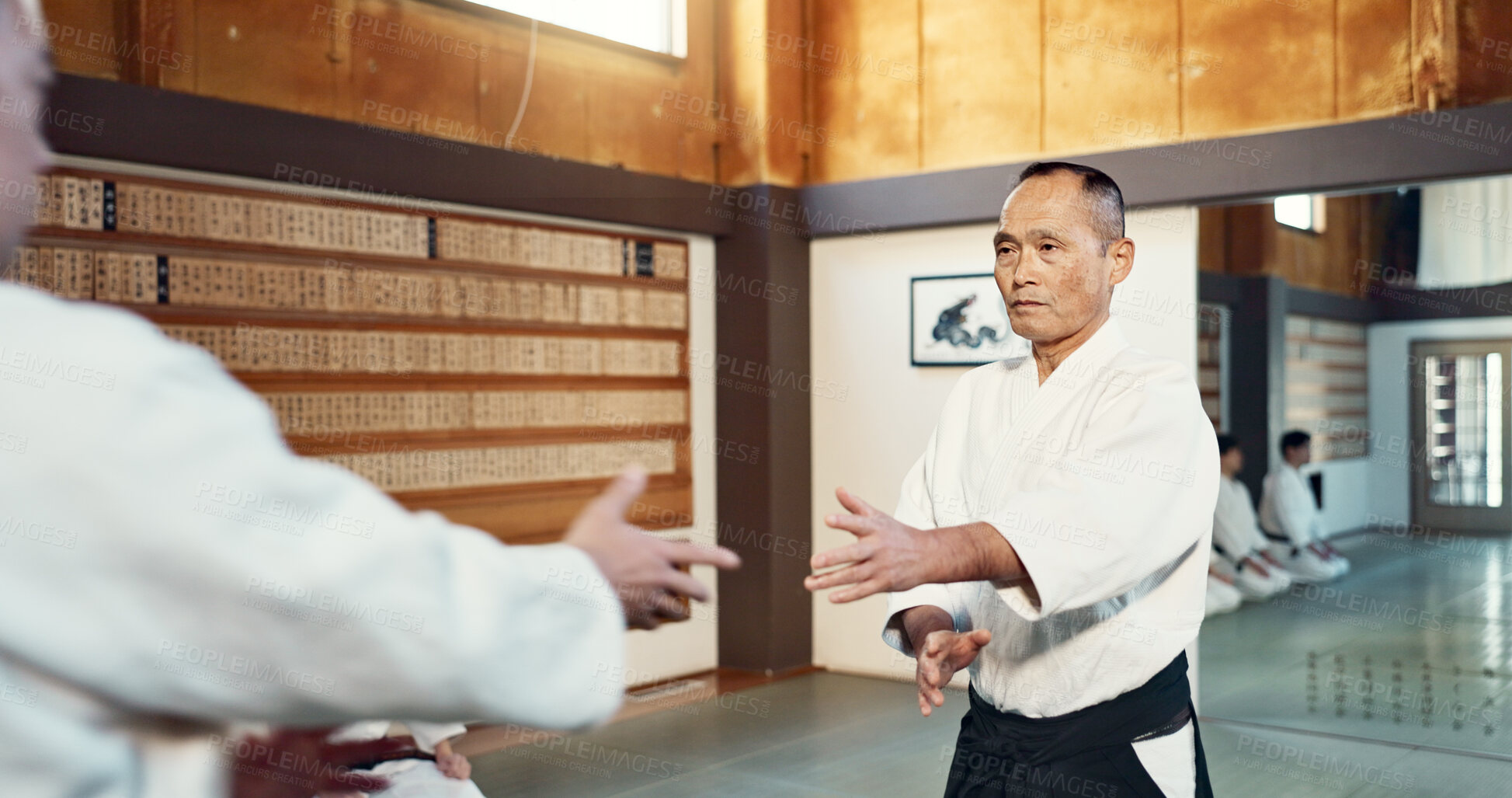 Buy stock photo Japanese sensei, aikido and instructor for fighting, modern martial arts and class in self defence. Teacher, respect and bow as trainer in life energy, man and strong in coaching in dojo place