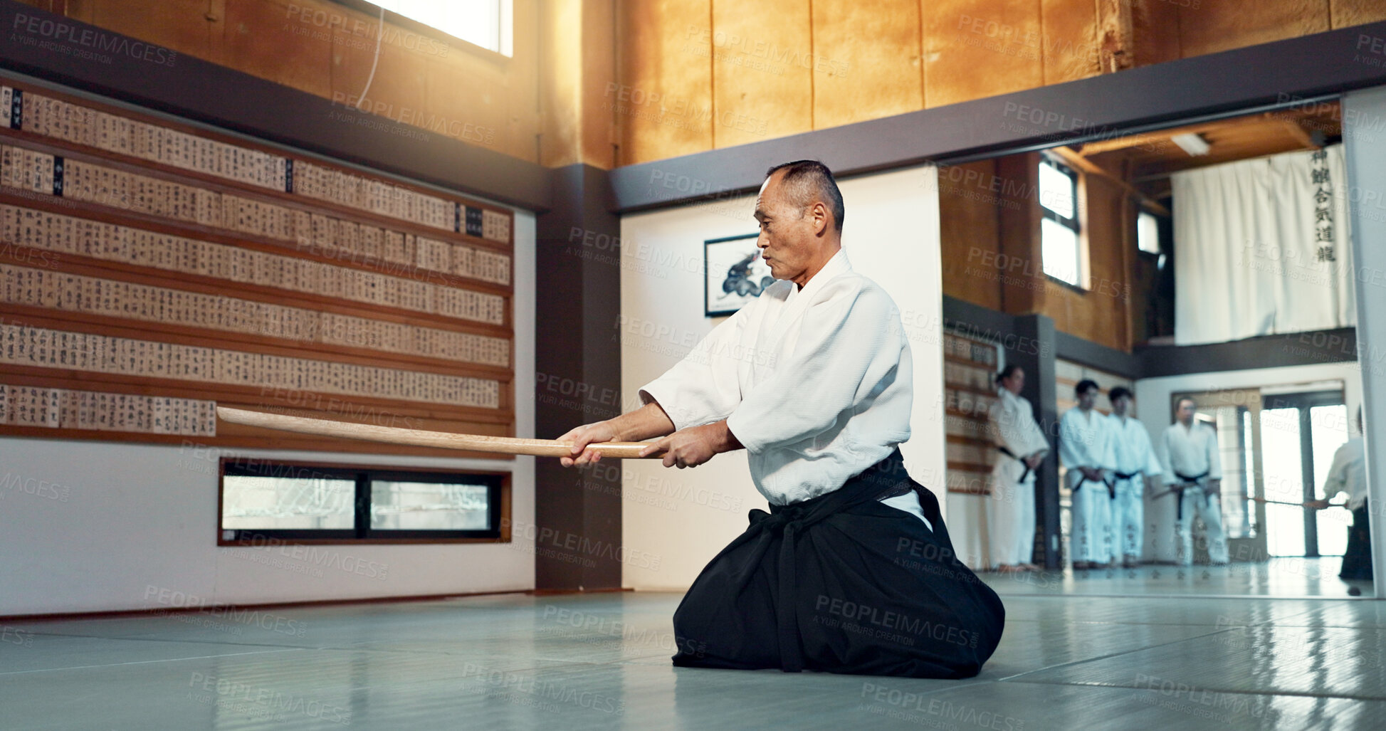 Buy stock photo Aikido sword, mature sensei and man teaching class, self defense or combat technique. Martial arts, Japanese person and wooden weapon for skills development, attack demonstration or bokken strike