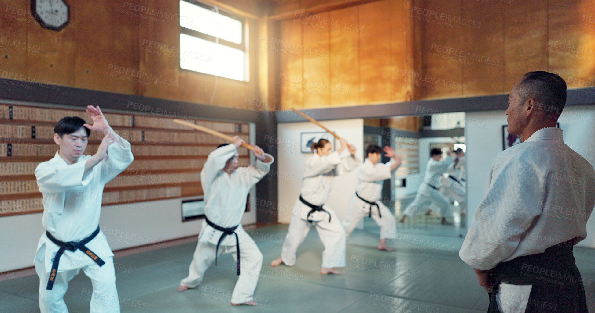 Buy stock photo Martial arts people, aikido class and sensei teaching protection, self defense or combat technique. Black belt students, education and Japanese group learning, skill development and practice in dojo