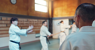 Japanese men, aikido class and instructor for fighting, modern martial arts and learning self defence. Teacher, students or exercise in life energy, training or strong in active combat for discipline