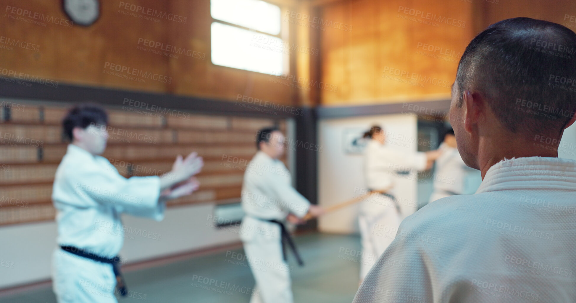 Buy stock photo Japanese men, aikido class and instructor for fighting, modern martial arts and learning self defence. Teacher, students or exercise in life energy, training or strong in active combat for discipline