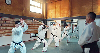 Buy stock photo Martial arts people, aikido class and sensei teaching protection, self defense or combat technique. Black belt students, education and Japanese group learning, skill development and practice in dojo