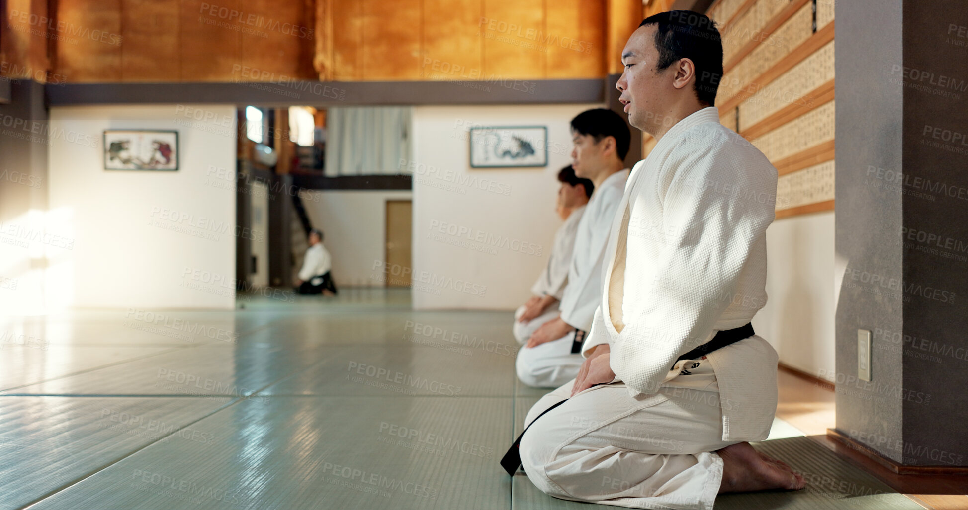 Buy stock photo Asian man, class and bow in dojo for respect, greeting or honor to master at indoor gym. Male person or group in karate bowing on floor for etiquette, attitude or commitment in martial arts together