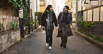 Couple, happy and meeting on walk in city, street and conversation with travel, vacation and care. Man, woman and together with chat, support and love on holiday on metro sidewalk in Tokyo