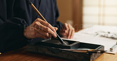 Buy stock photo Hands, brush in ink for writing and Japanese calligraphy or ancient script for art and inkstone. Asian creativity, black paint and vintage tools, paintbrush and person with traditional stationery