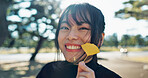 Asian, happy woman in park and leaf with face and explore nature for wellness and outdoor environment. Sunshine, plants and portrait, travel and adventure in public garden with smile on journey