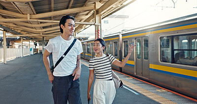 Walking, conversation and young couple by train station for exploring on vacation or holiday. Travel, happy and Asian man and woman talking by public transport for adventure together on weekend trip.
