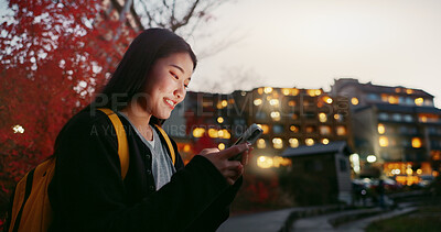Buy stock photo Happy asian woman, phone and night at city for social media, communication or outdoor networking. Female person smile on mobile smartphone in late evening for online chatting in urban town of Japan