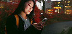 Happy asian woman, phone and night for communication, social media or outdoor networking in city. Female person relax on mobile smartphone in late evening for online chatting in urban town of Japan