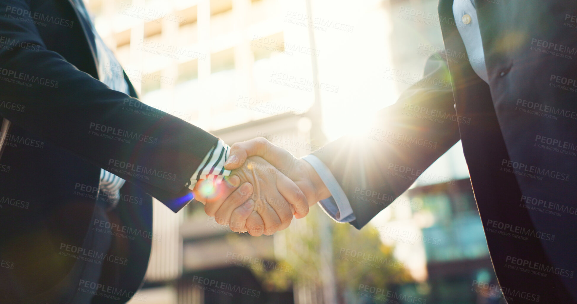 Buy stock photo Business people, handshake and city for partnership, agreement or greeting in outdoor deal or meeting. Closeup of employees shaking hands outside for b2b, teamwork or hiring in an urban town together