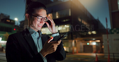 Phone, night and Asian businessman in the city networking on social media, mobile app or internet. Technology, smile and young professional male person with cellphone for research in town at night.