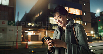 Buy stock photo Asian woman, phone and typing in night city for communication, social media or outdoor networking. Young business female person on mobile smartphone for late evening chat or texting in an urban town