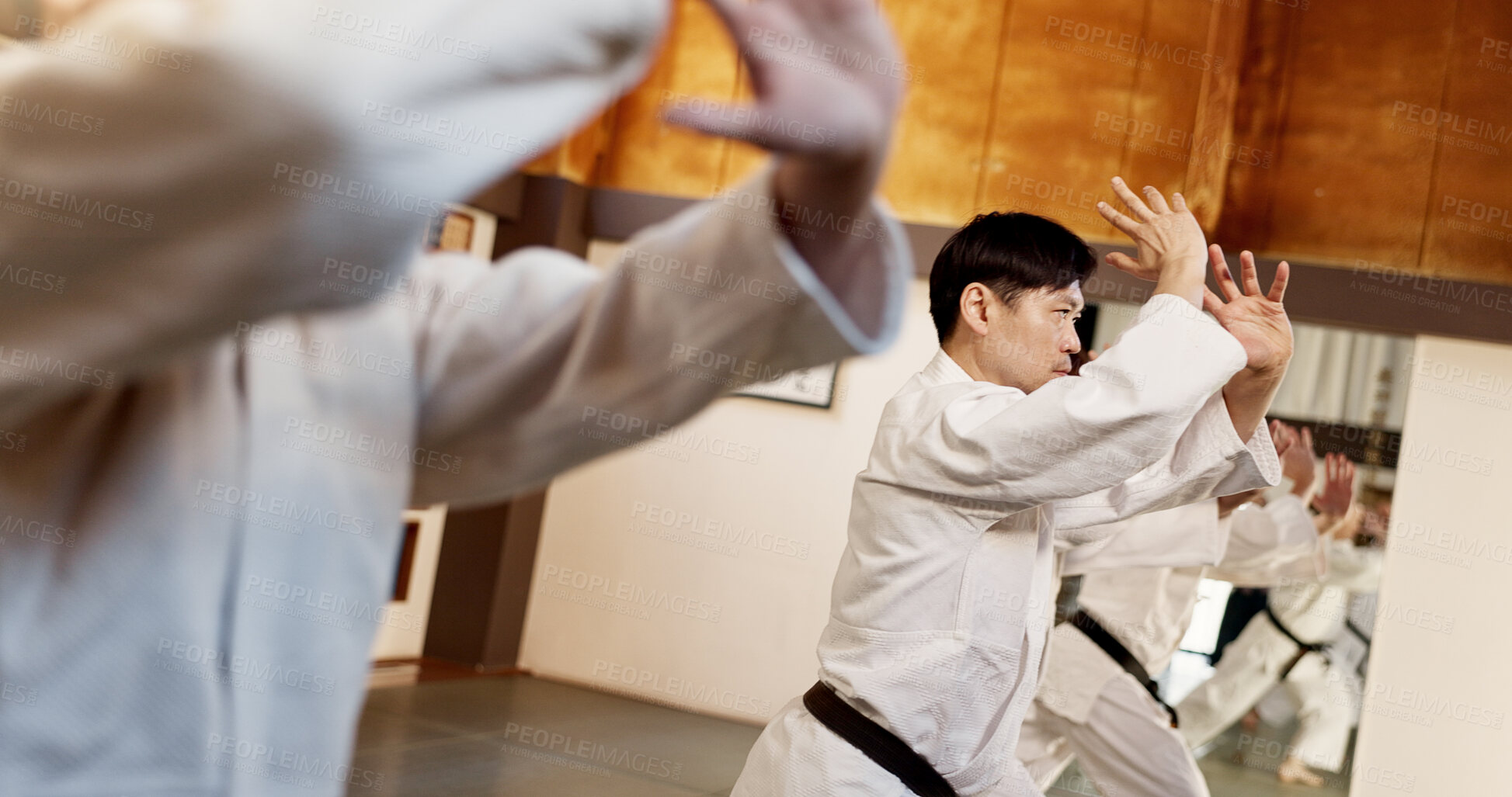 Buy stock photo Aikido class, group and people for martial arts, strike or together for combat at training, gym or dojo. Black belt students, fight and exercise for workout, fitness and conflict at Japanese club