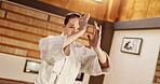 Exercise, aikido or woman learning martial arts in dojo for practice, body movement or self defense. Combat routine, wellness or female person in training workout for fighting, education or class