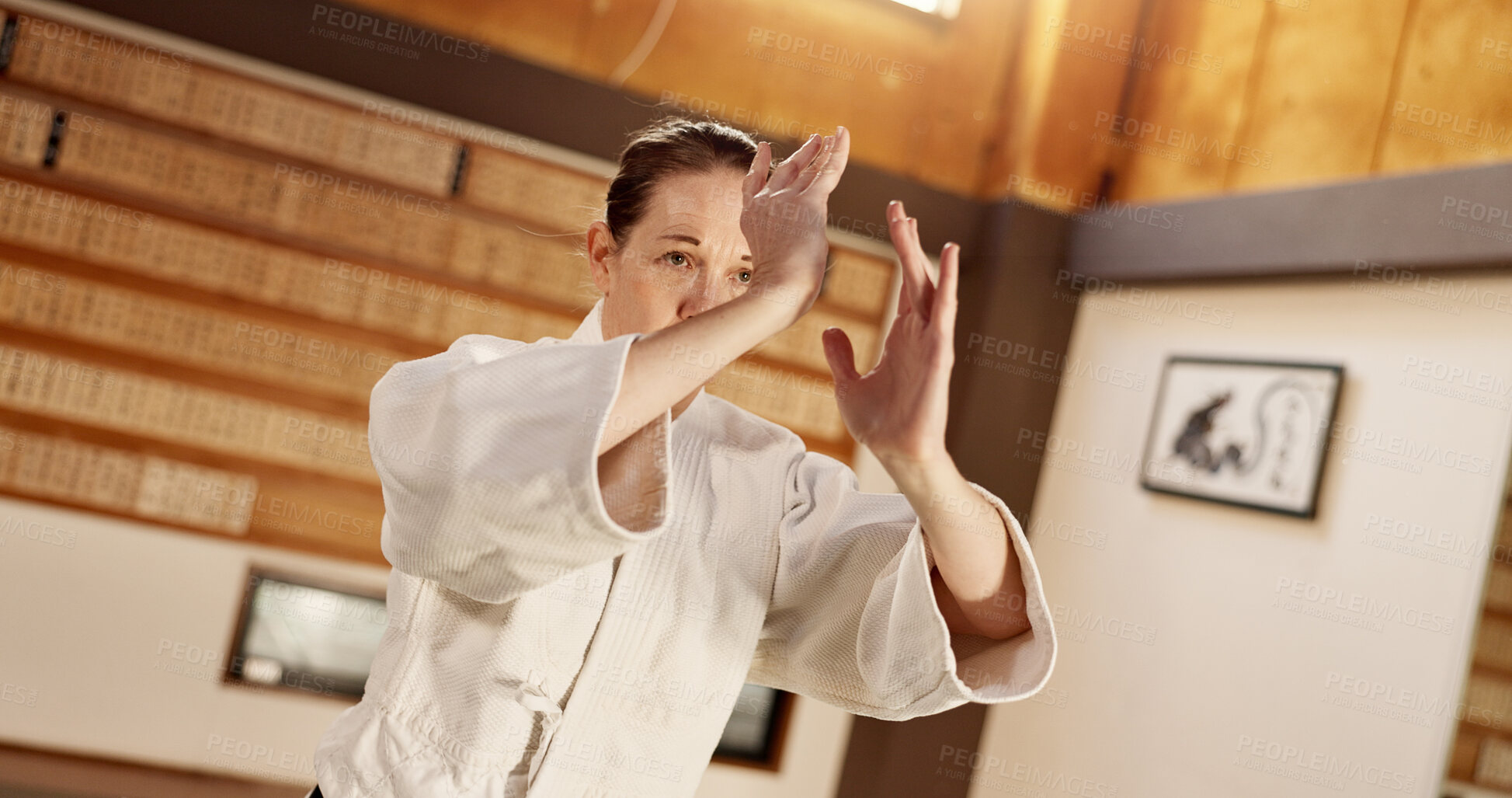 Buy stock photo Aikido class, woman and fight for martial arts, strike or together for combat at training, gym or dojo. Japanese person, student and hands for exercise, workout or fitness with zen, conflict or club