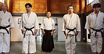 Black belt students, bow or sensei in dojo for aikido practice, discipline or self defense. Combat demonstration, Japanese people learning or ready to start training for fighting class or education