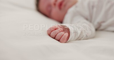 Hand, newborn and sleeping on bed in nursery with relaxing, resting and nap on blanket in morning. Baby, peaceful and dreaming in bedroom of home for child development, growth and nurture or relax