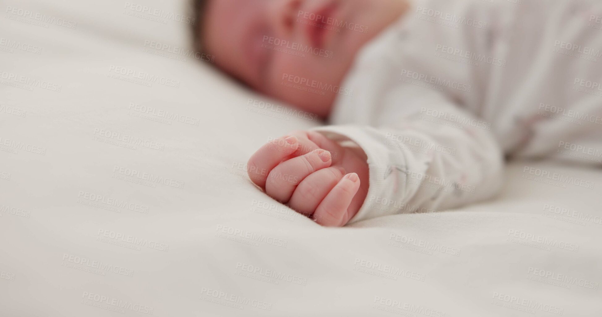 Buy stock photo Hand, newborn and sleeping on bed in nursery with relaxing, resting and nap on blanket in morning. Baby, peaceful and dreaming in bedroom of home for child development, growth and nurture or relax