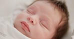Baby, sleeping face and nursery bed with morning, nap and dreaming of a young newborn at home. Cozy, sleepy kid and calm with health development from rest and peace in a house with closeup and care