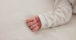 Hand, baby and sleeping on bed in nursery for child development, childcare and nurture in home. Newborn, resting or relaxing in bedroom with rest, dreaming or closeup for wellness and health in house