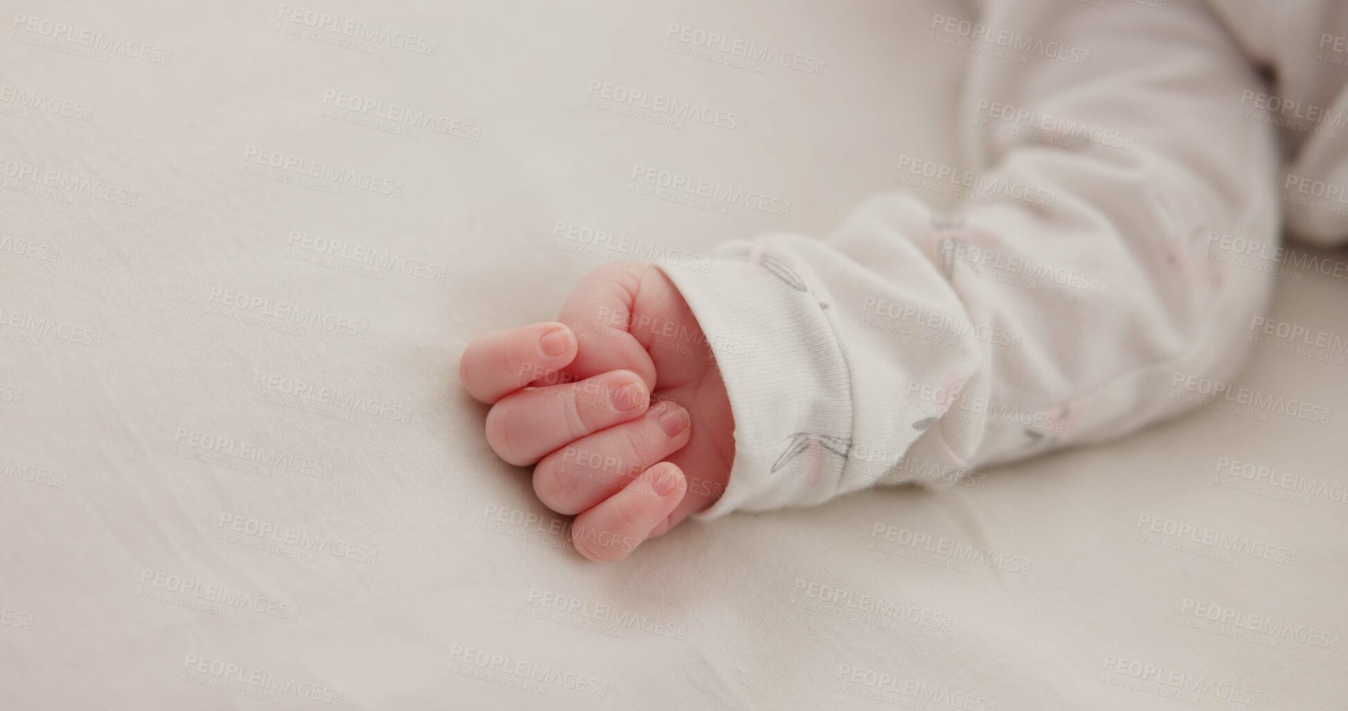 Buy stock photo Hand, baby and sleeping on bed in nursery for child development, childcare and nurture in home. Newborn, resting or relaxing in bedroom with rest, dreaming or closeup for wellness and health in house