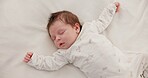 Cute, sleeping and newborn baby on a bed at a home in the bedroom for resting and dreaming. Tired, sweet and top view of infant, child or kid taking a nap in the morning in nursery at family house.