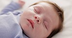 Face, growth and sleep with a baby on a bed closeup in a home, dreaming during a nap for child development. Relax, calm and rest with an adorable newborn infant asleep in a bedroom for comfort