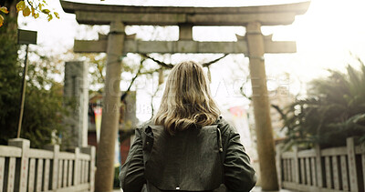 Buy stock photo Woman, nature and torii gate in Kyoto with backpack, tourist and back with traditional history. Architecture, japanese culture and shinto shrine in woods with sculpture, memorial and monument