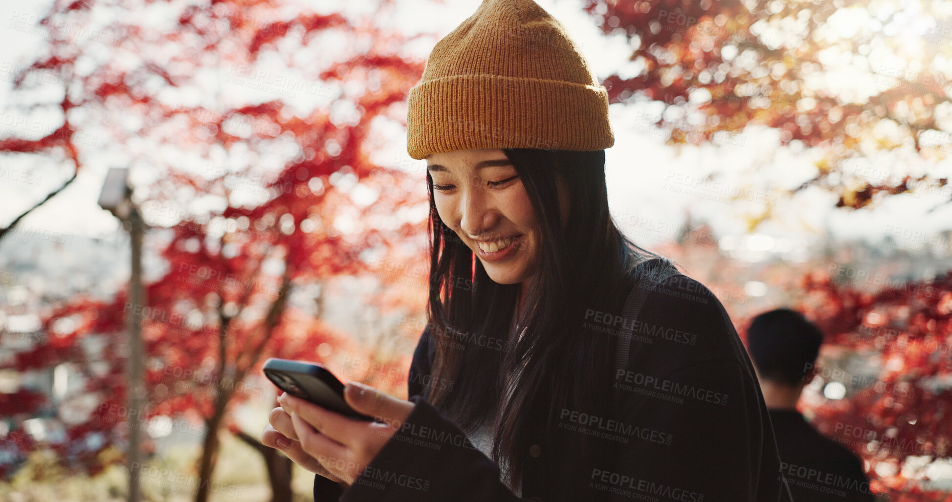 Buy stock photo Phone, search and Japanese woman in forest for holiday, vacation and adventure in Japan. Happy smile, autumn leaves and girl with smartphone for online search, social media or memory for travel blog.