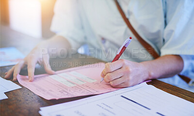 Buy stock photo Cropped shot of a doctor filling out paperwork in a hospital