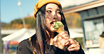 Japanese woman, ice cream and eating in city, summer and walk with thinking, memory or ideas on vacation. Girl, person and gelato for food, dessert and vision with taste, tourism and happy in Tokyo