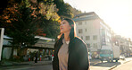 Japanese woman, walking and thinking in city, street and sunshine with vision, ideas or vacation. Girl, person and outdoor on metro sidewalk, road or happy for vacation, adventure or journey in Tokyo