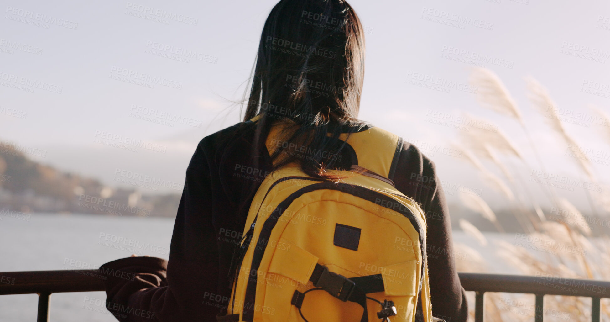 Buy stock photo Woman, water and backpack with back, thinking and mountains on adventure, trip or vacation in nature. Girl, person and ideas on holiday with bag, vision and memory by lake, river and bridge in Tokyo