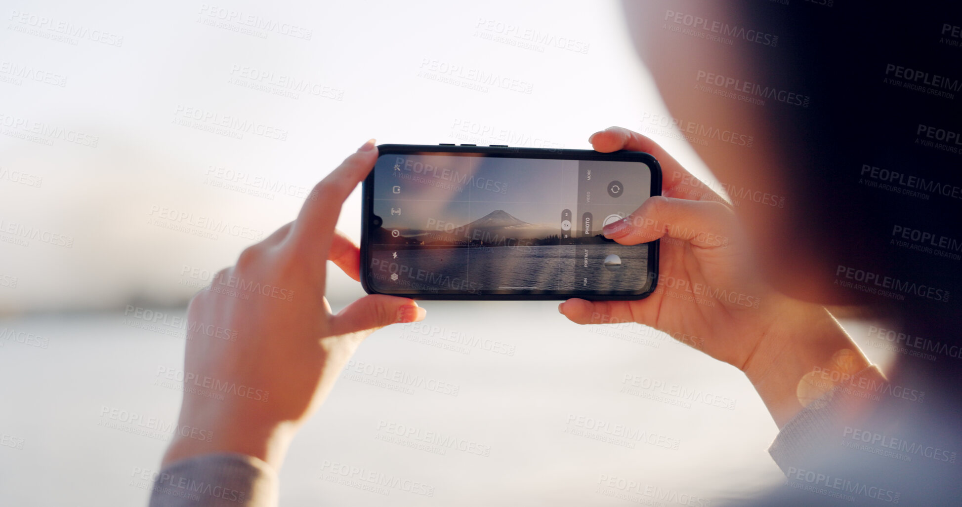 Buy stock photo Hands, phone and photography by lake, mountain and nature with landscape, horizon and outdoor adventure. Person, smartphone screen and camera for Mt Fuji, memory and post on social media in Japan