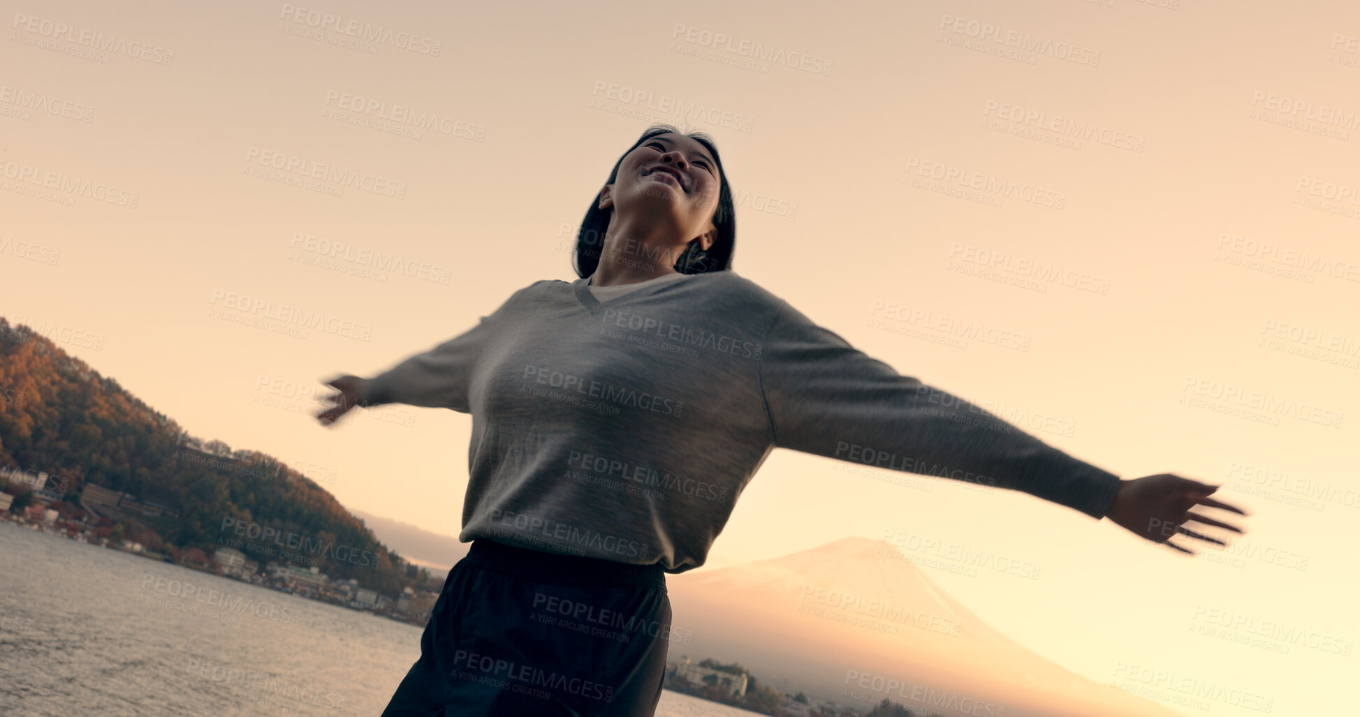 Buy stock photo Japanese woman, freedom and happiness outdoor, lake or ocean with travel, holiday and mindfulness in nature. Wellness, adventure and care free at beach in Japan, smile with spinning and positivity
