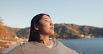 Japanese woman, freedom and peace outdoor, lake or ocean with travel, holiday and mindfulness in nature. Wellness, adventure and care free at beach in Japan, happy with breathing and positivity