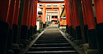 Stairs in Torii gate tunnel with temple, peace and mindfulness on travel with spiritual history. Architecture, Japanese culture and steps on orange path at Shinto shrine monument in forest in Kyoto