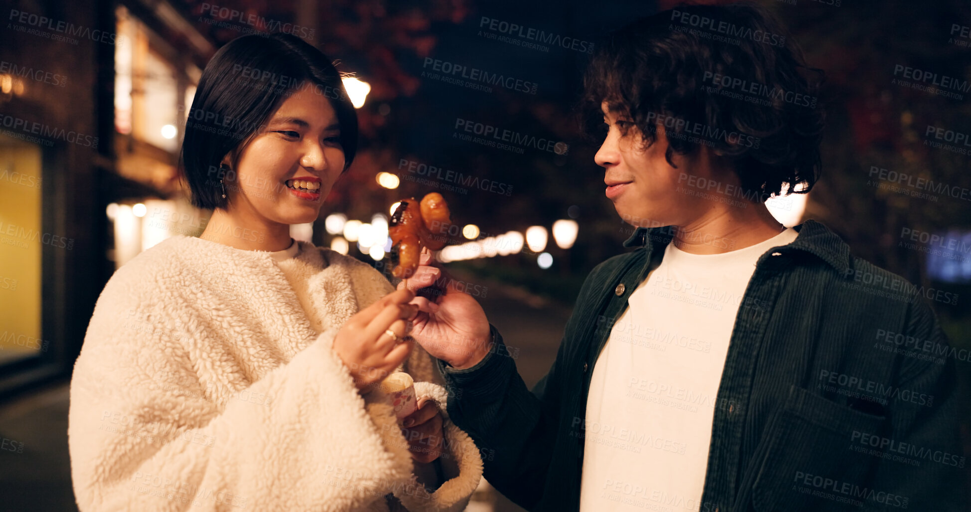 Buy stock photo Women, friends and eating street food or travel Japan for night snack, experience or dessert. Female people, sidewalk and sweet donut on vacation for nutrition or culture, adventure or traditional