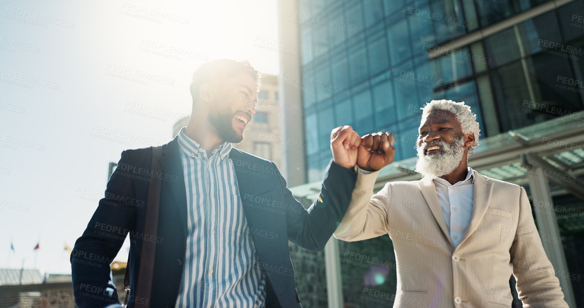 Buy stock photo Business men, fist bump and team in street with smile, support and respect on walk to investment company. Partnership, friends and staff with hello, happy and commute on city sidewalk in Cape Town