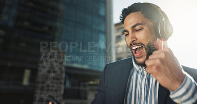 Happy, dance and businessman with headphones in city for job promotion celebration with phone. Smile, cellphone and excited professional young male person listening to music, radio or album in town.