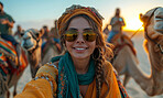 Selfie, desert and camel with smartphone for travel, freedom or vacation. Health, activity and outdoors with friends group and sunset view for wellness, motivation or discovery in nature